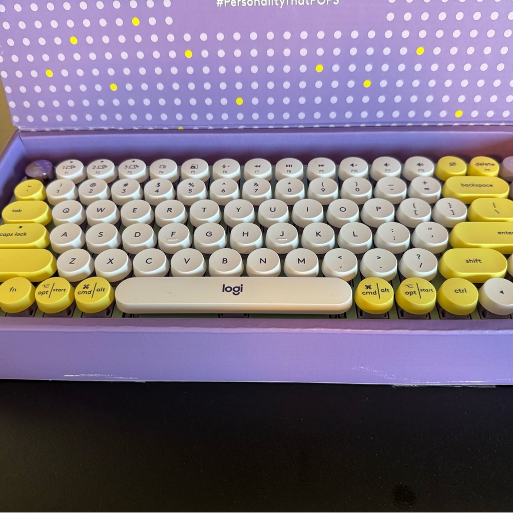 Logitech Wireless Keyboard and mouse in Purple, Yellow and White.